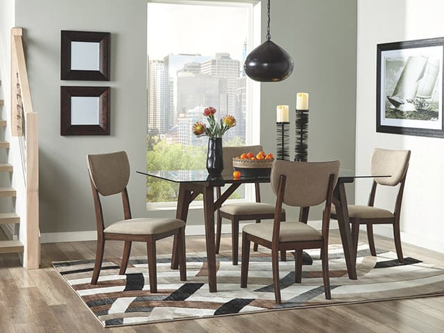 An Ashley dining room set, with area rug, framed pictures and accessories such as a vase and candles