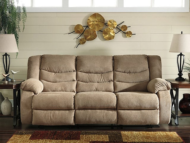 An Ashley sofa, with endtables and decor pieces